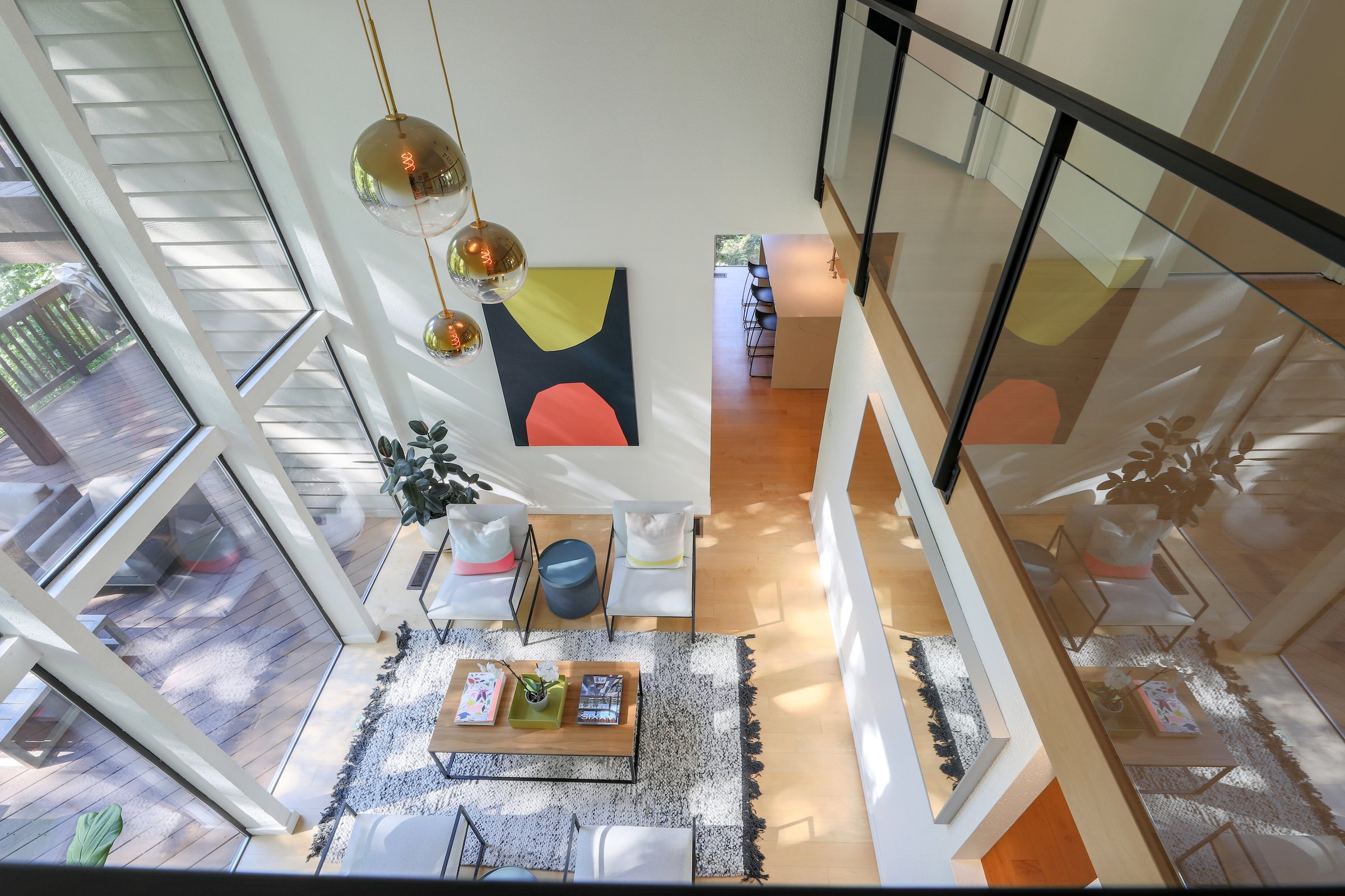 Looking down through the glass railings into the main living space