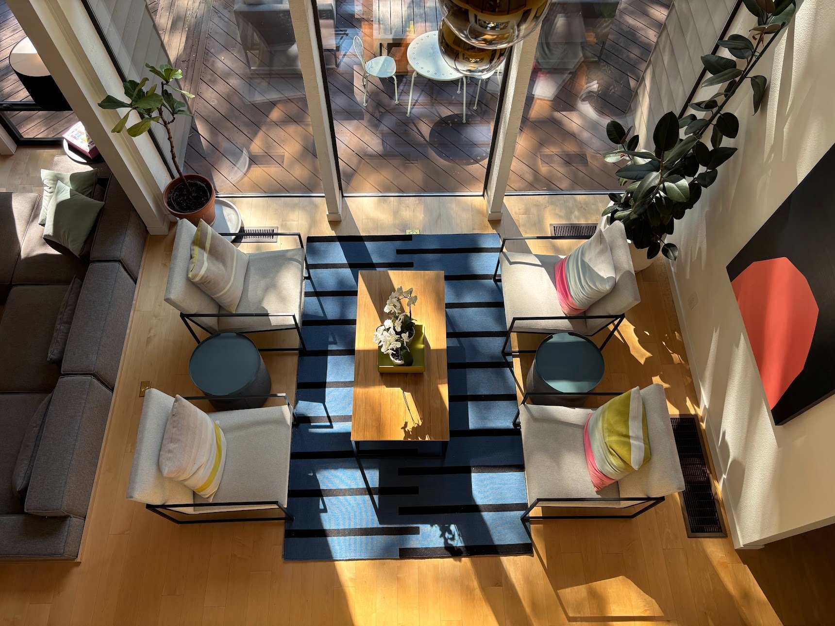 The living room looking south through eleven windows into the forest canopy